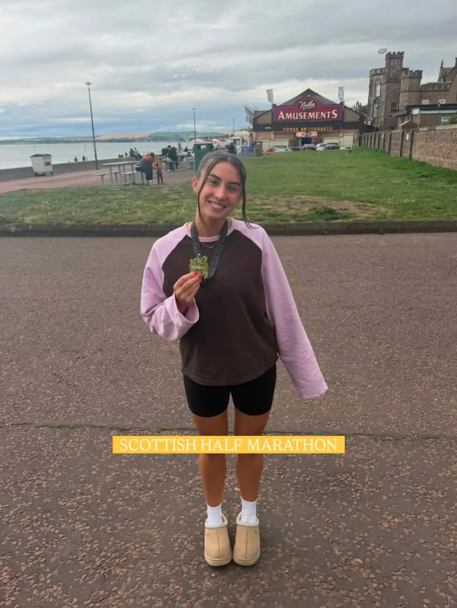 A CMAX member with her Scottish Half Marathon medal